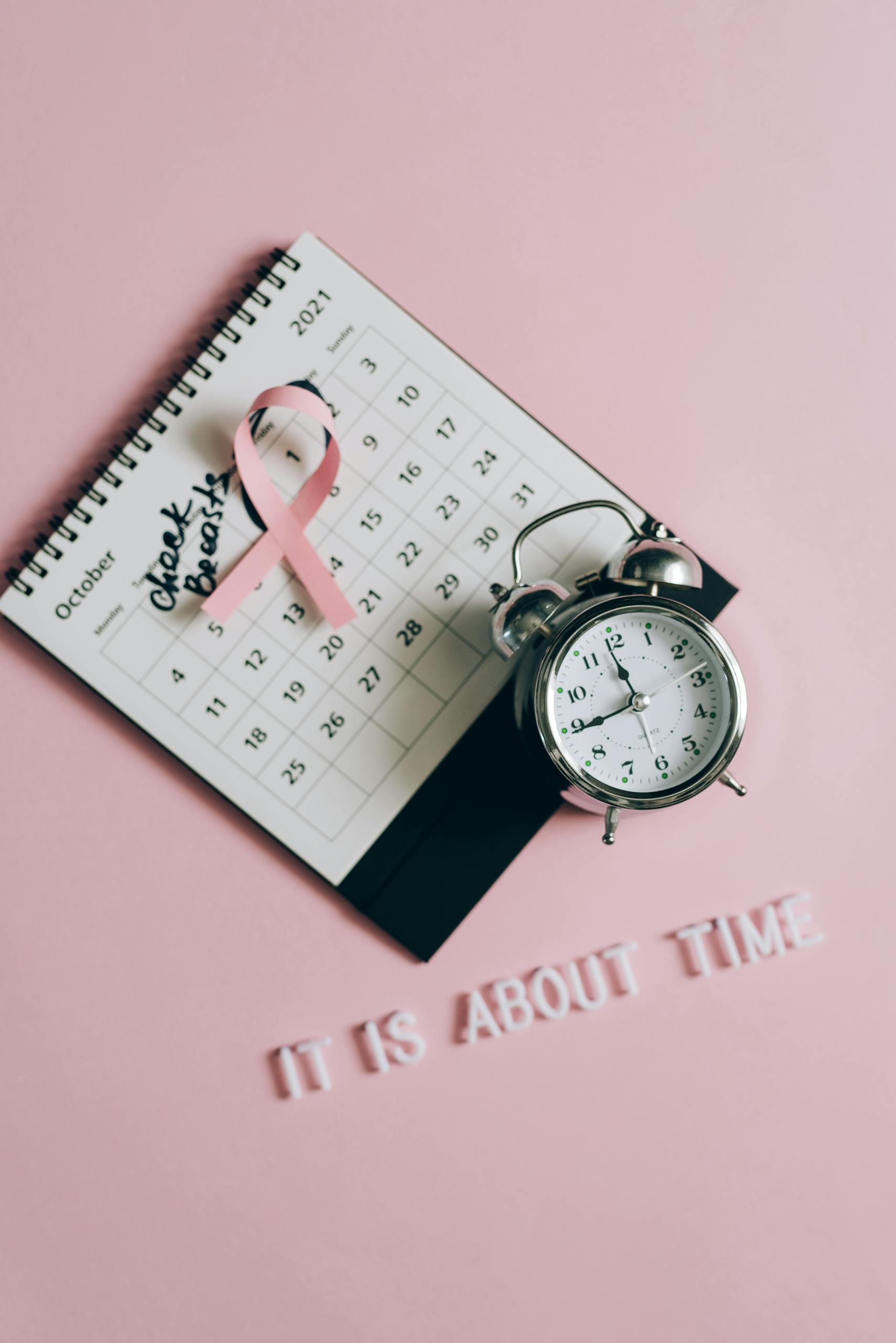 Close-Up Shot of a Pink Ribbon on a Calendar